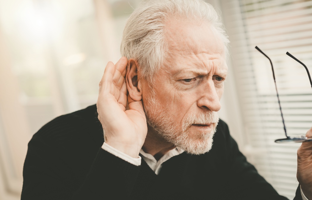 Portrait of senior man having hearing problems