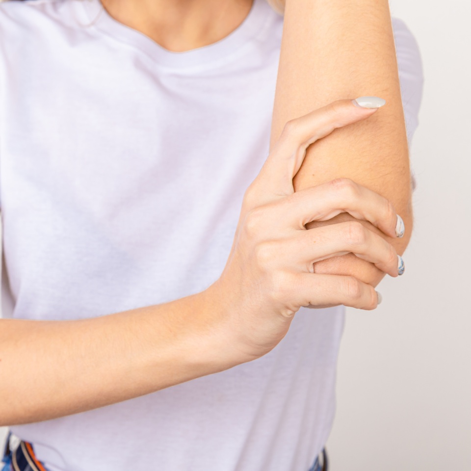 Young girl with pain in elbow, joint inflammation isolated on white background