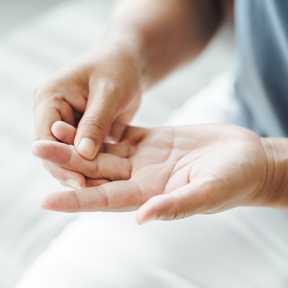 Woman suffering from hand and finger joint pain. Causes of rheumatoid arthritis, carpal tunnel syndrome, gout. Health care and medical concept.