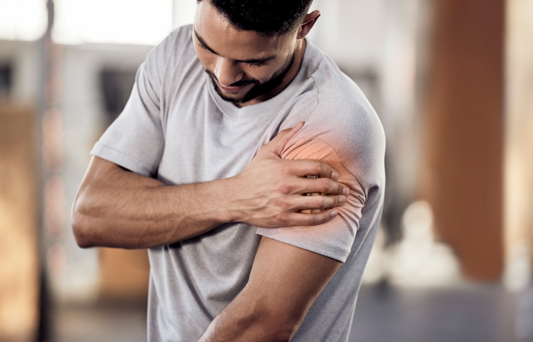 Man, gym or bodybuilder with shoulder pain in workout, training injury or fitness cardio in accident. Red glow, hurt arm muscle or injured athlete in exercise emergency with bruise, ache or agony