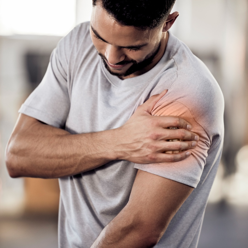 Man, gym or bodybuilder with shoulder pain in workout, training injury or fitness cardio in accident. Red glow, hurt arm muscle or injured athlete in exercise emergency with bruise, ache or agony