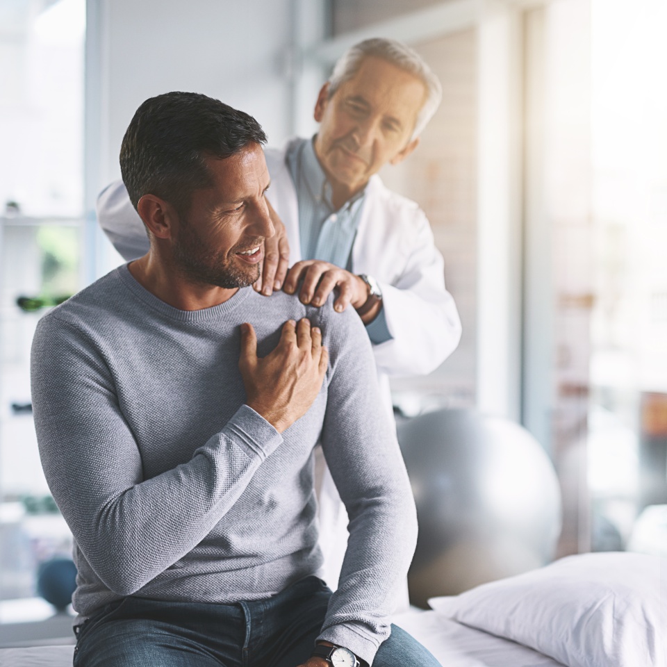 Elderly doctor, man and patient with shoulder pain for physical therapy, healthcare or body recovery. Orthopedic, physician and medical expert for arm consultation with examination, advice or healing