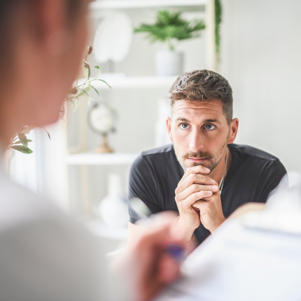 A Man with psychologist theraphy social problems concept drug addiction talk to a psychological woman