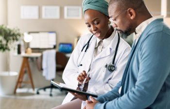 Tablet, patient and consultation with doctor for healthcare, insurance or exam results. African people, technology and medical professional explain treatment for wellness, checkup and help in clinic