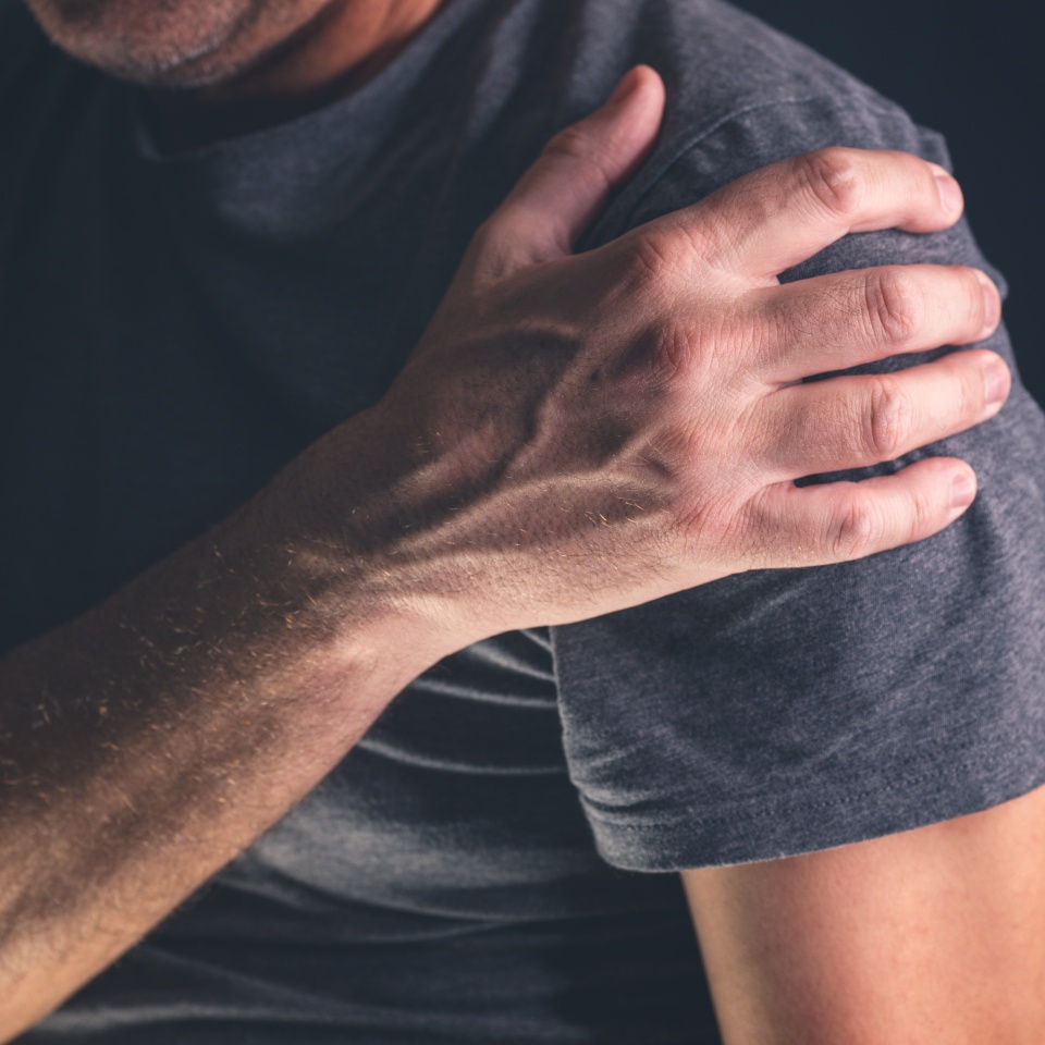 Aching frozen shoulder pain as symptom of rotator cuff tendinitis, adult caucasian male suffering from chronic bursitis, selective focus