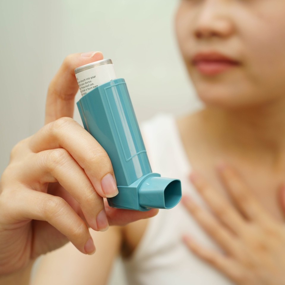 Asthma and chronic obstructive pulmonary disease COPD, Asian teenage using metered dose inhaler MDI.