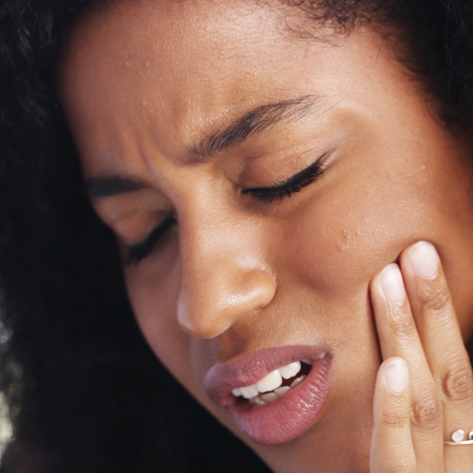 Toothache, sad and face of African woman at home for dental decay, poor oral hygiene and gum health pain. Gingivitis, bad breath and cavity bacteria with person for inflammation, tmj and crisis