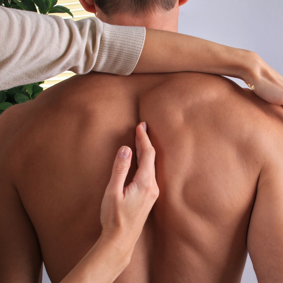 Man having chiropractic back adjustment close up. Osteopathy, Alternative medicine, pain relief concept