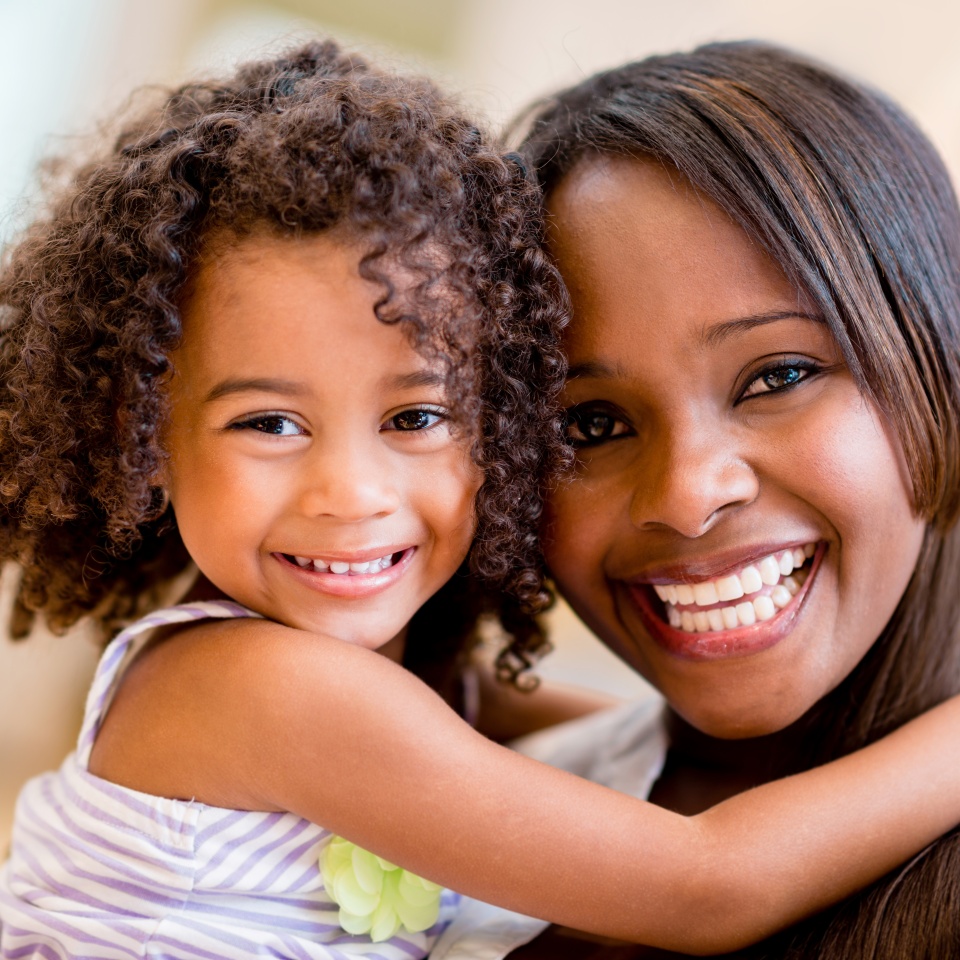 Happy portrait of a mother and daughter smiling