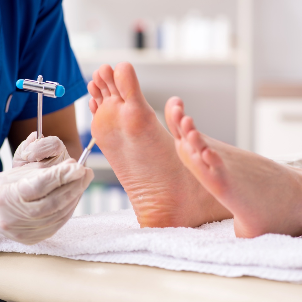 Podiatrist treating feet during procedure