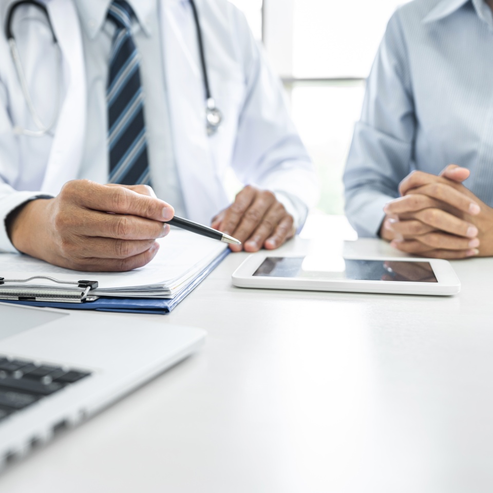 Professor Doctor consulting with patient discussing something and recommend treatment methods, Presenting results on report and x-ray film, Medicine and health care concept.