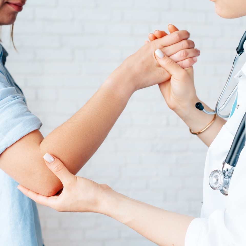 the doctor makes a consultation to a girl whose arm hurts