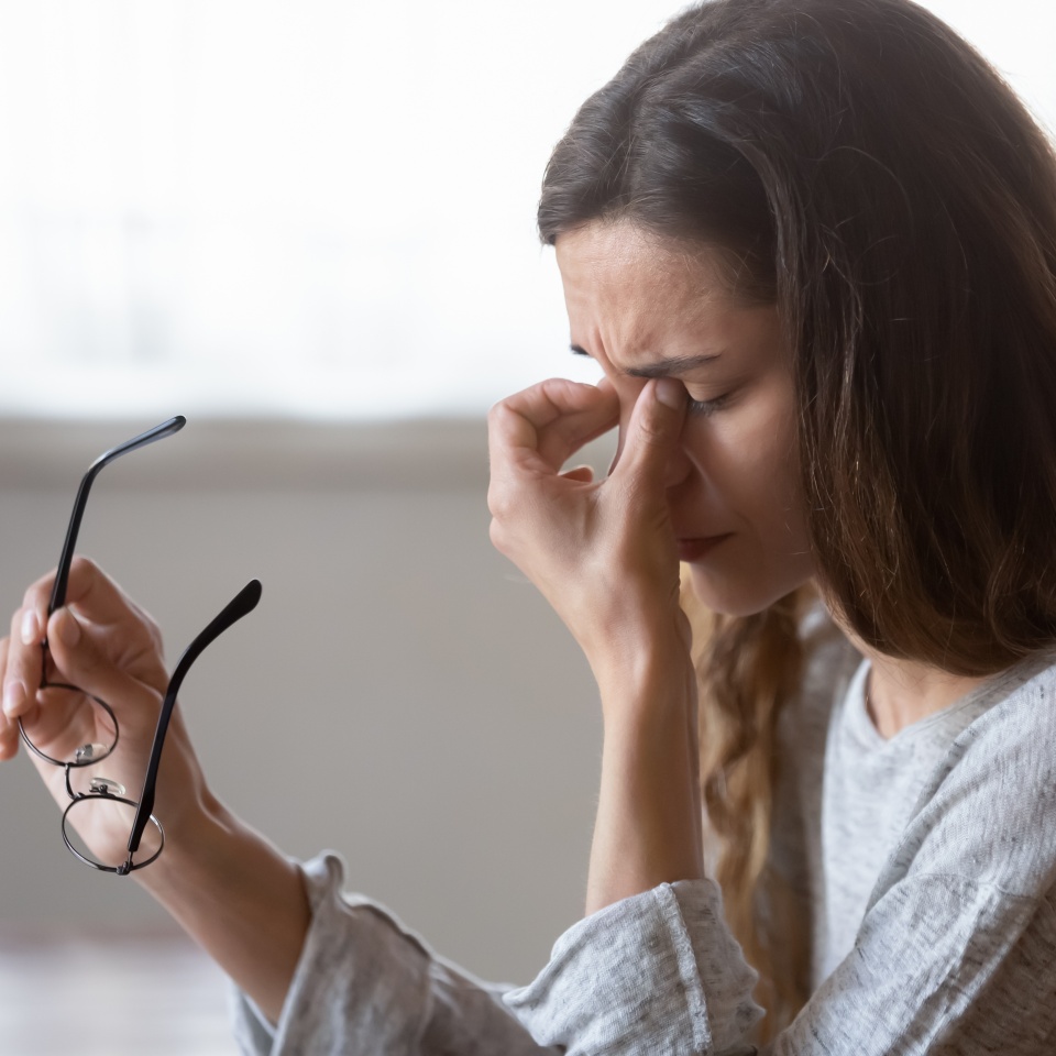 Close up exhausted woman massaging eyelids, taking off glasses, tired freelancer or student suffering from eyestrain or dry eye syndrome, feeling dizziness or headache after long hours work