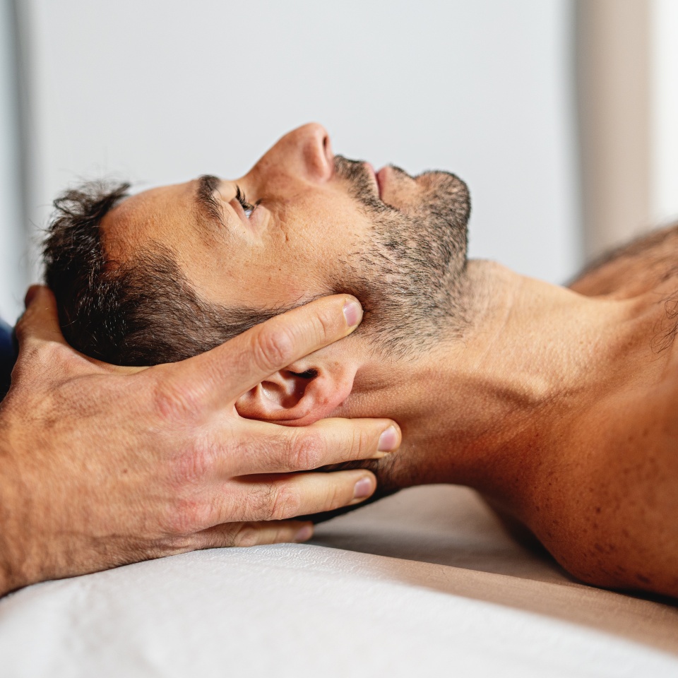 Gentle craniosacral therapy performed by an osteopath, targeting neck pain.