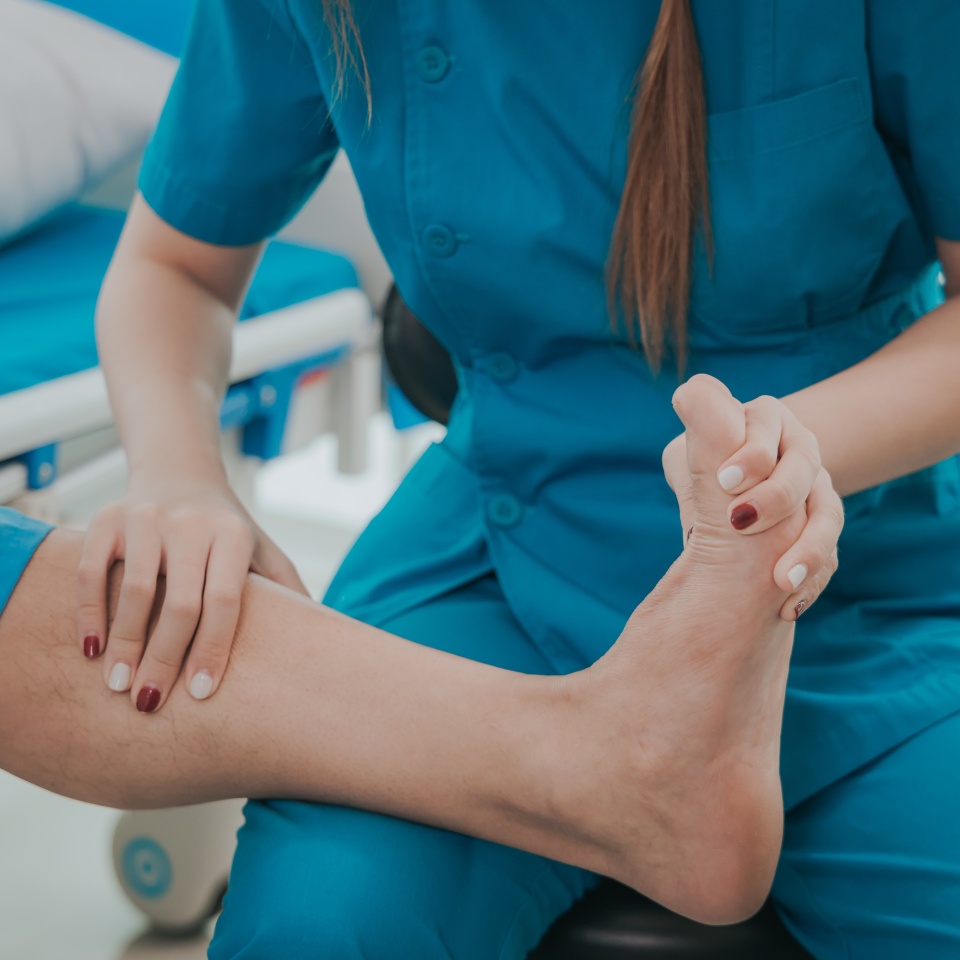 Asian female physical therapist helps an elderly man stretch his Achilles tendon, physical therapy rehabilitation, elderly. Causes knee pain, swelling, redness, stiffness of the knee, and a rumbling s