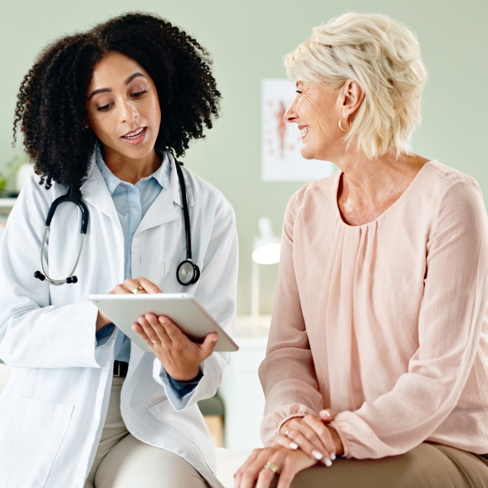 Woman, doctor and consulting patient with tablet in checkup for medical results, diagnosis or prescription at hospital. Female person talking to client for consultation, help or advice at clinic