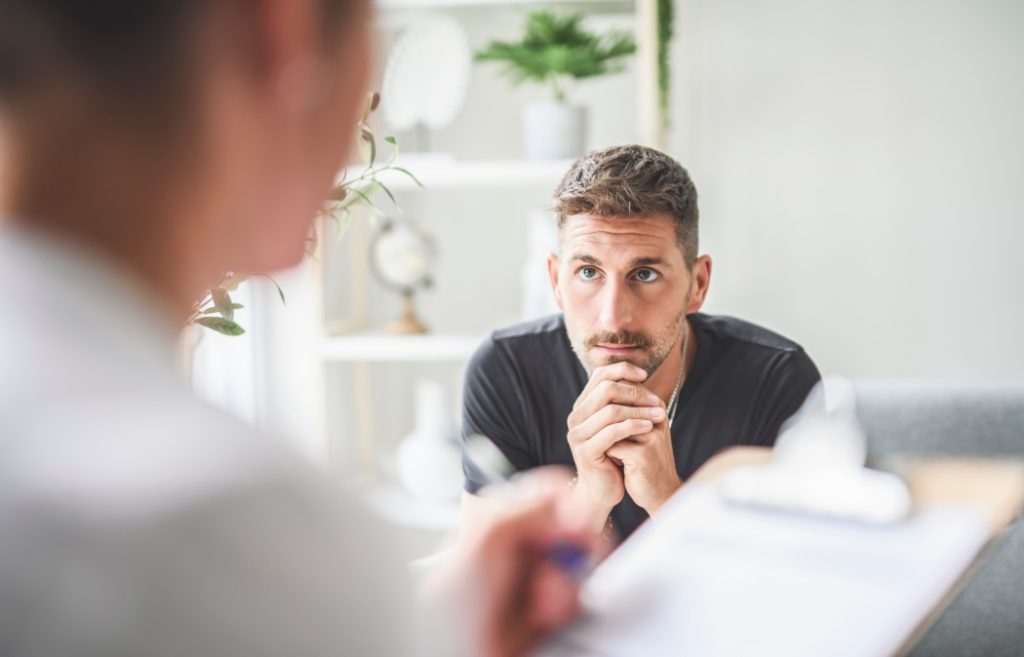 A Man with psychologist theraphy social problems concept drug addiction talk to a psychological woman