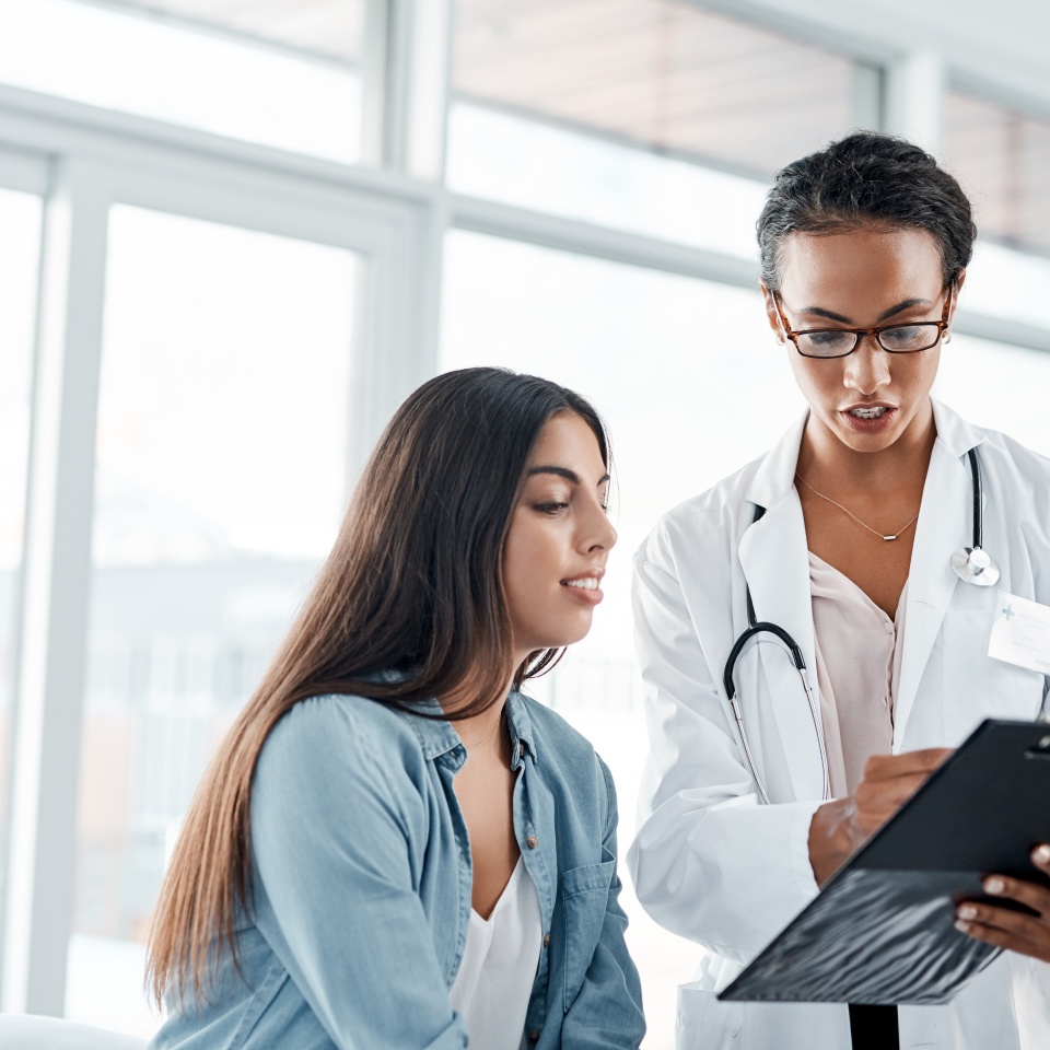 Healthcare, patient and gynecologist for consultation, diagnosis and prescription in office or hospital. Female people, advice and medical checklist for symptoms, support or wellness clinic by doctor