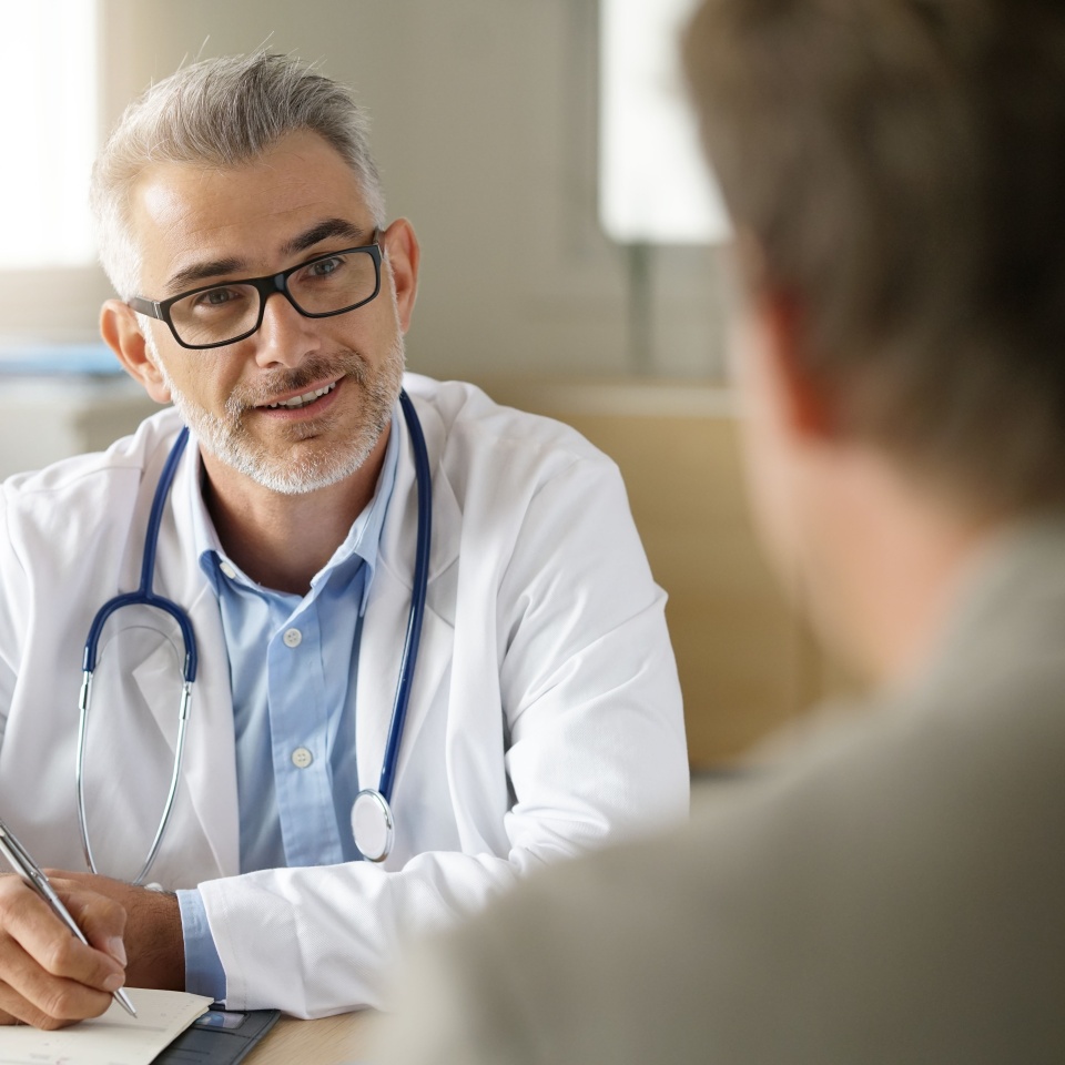 Doctor talking to patient in office